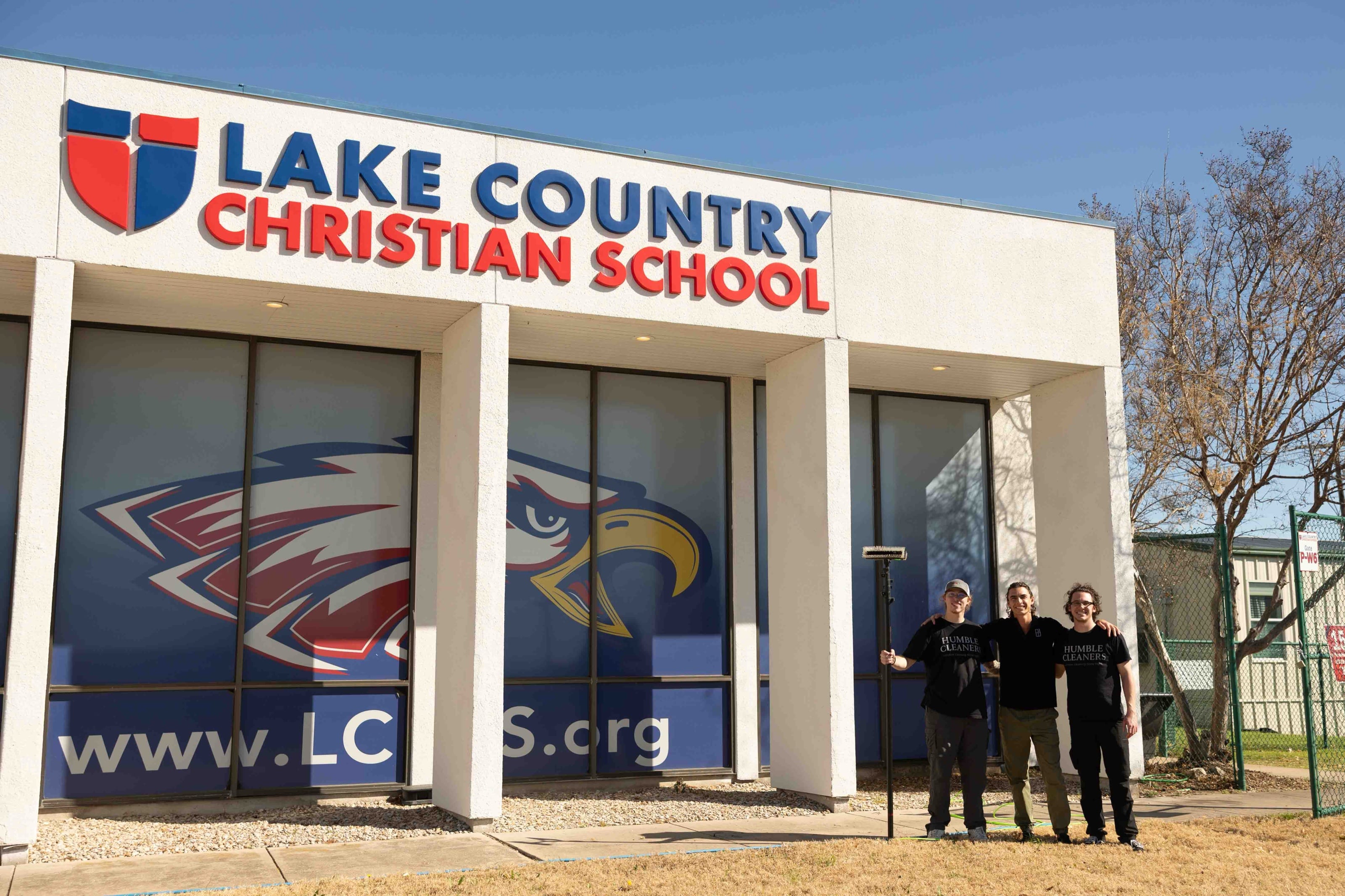 The Humble Cleaners crew in front of Lake Country Christian School after cleaning its storefront glass